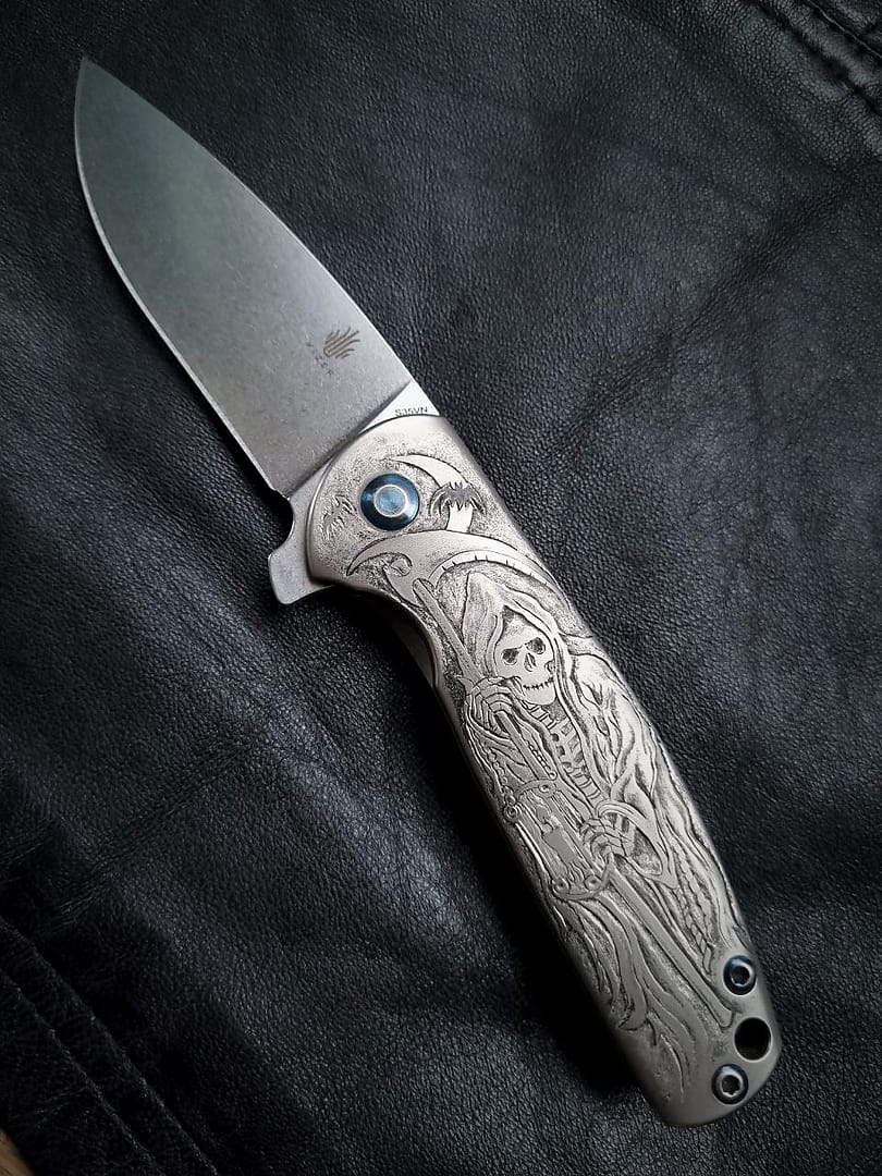 Hand engraved in a titanium Kizer Gemini knife handle.